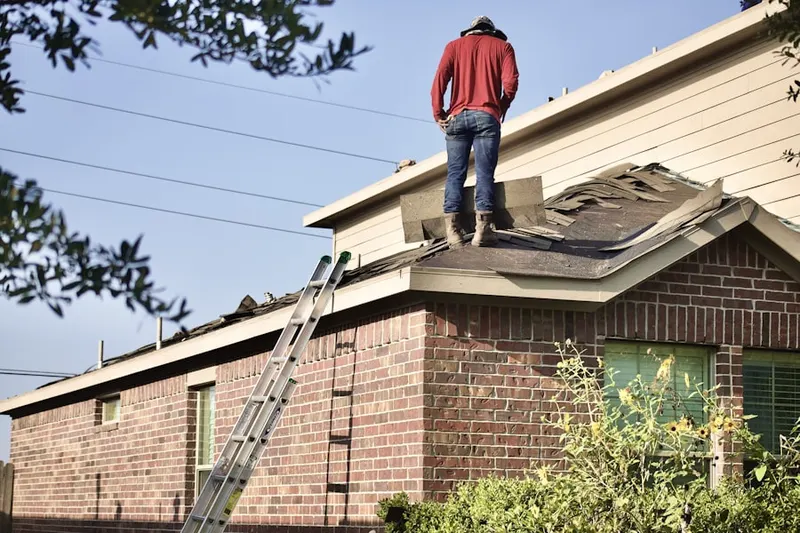 Professional roofer working on a residential roof in Colony Village